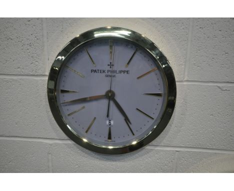 A PATEK PHILIPPE GENEVE DEALERS ADVERTISING WALL CLOCK, with a brassed frame, and a grey dial, diameter 40cm (condition repor