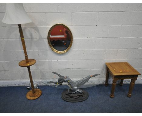 AN OVAL GLASS TOP COFFEE TABLE, the glass held by a lady, width 120cm x depth 66cm x height 44cm, an oak lamp table, an oak s