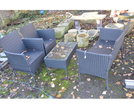 A MODERN RATTAN EFFECT GARDEN PATIO SET, consisting of a two seat sofa, width 100cm, two chairs and a glass topped coffee tab