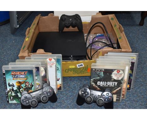 A BOX CONTAINING A PLAYSTATION 3 CONSOLE AND GAMES, includes Ratchet &amp; Clank Tools of Destruction, Ratchet &amp; Clank Qu