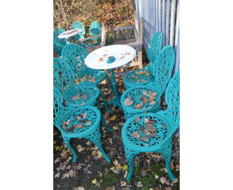 A SET SIX OF MODERN CAST GARDEN CHAIRS, with foliage and hummingbird to back rest, and a Victorian style cast iron pub table,