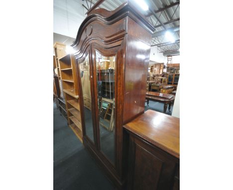 A 19TH CENTURY FRENCH FLAME MAHOGANY TWO DOOR WARDROBE, with bevelled edge mirror doors, enclosing a single drawer above anot