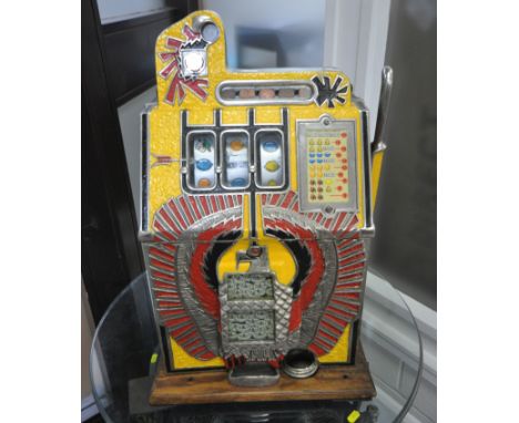 MILLS NOVELTY CO, AN EARLY 20TH CENTURY THUNDERBIRD DESIGN PAINTED CAST IRON AND WOODEN CASED SLOT MACHINE, the mechanism mad