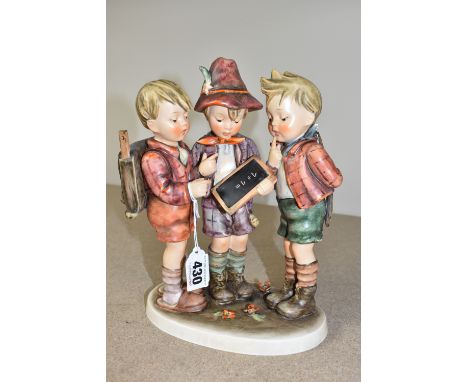 A GOEBEL HUMMEL 'SCHOOL BOYS' 170/III FIGURE of three school boys looking at small chalkboard, height 25cm (1) (Condition Rep