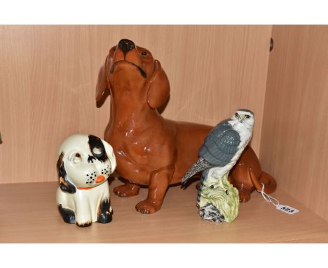 THREE CERAMIC FIGURES, comprising a Beswick tan Fireside Model Dachshund model no 2286, height 26.5cm, a Beswick 'Merlin' Ben