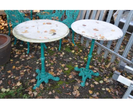 A PAIR OF VICTORIAN STYLE CAST IRON PUB TABLES with a tripod base and a white marble top, 59cm in diameter and 79cm high, Con