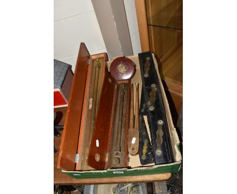 A BOX OF TECHNICAL DRAWING EQUIPMENT, comprising two cased brass parallel rolling rules, four parallel rules, the largest mar