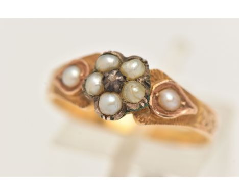 A YELLOW METAL SPLIT PEARL AND DIAMOND MEMORIAL RING, designed as a flower set with a very small central diamond chip, within