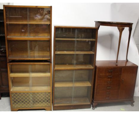 An early/mid-20th century 'Fyne Ladyes' music cabinet, a demi-lune mahogany hall table, a mid-20th century two-shelf bookcase