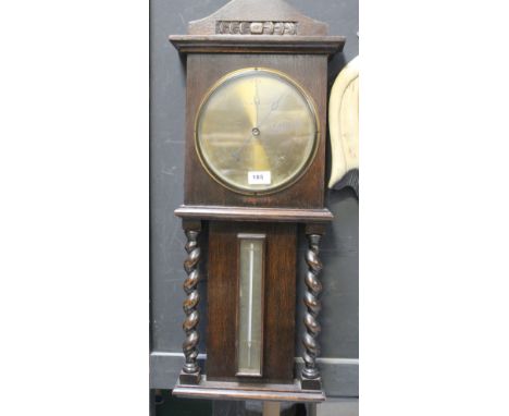 A 1930s oak aneroid barometer /thermometer with barleytwist uprights.