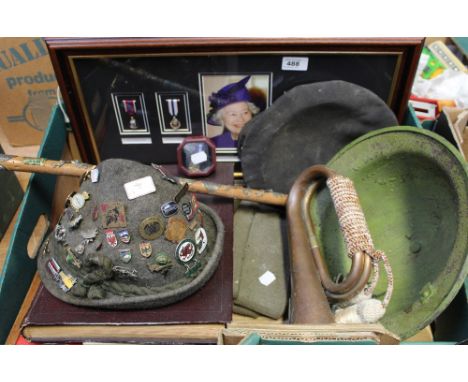 A WWII British Army tin helmet, two British Army berets, one with cap badge , a chauffeur's black hat, a Tyrolean hat adorned