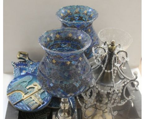 A pair of large decorative blue mosaic glass candle holders on white metal and wood stands, a clear glass crackle glaze candl