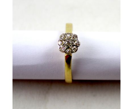A yellow metal ladies' diamond daisy ring, size V, approx 3.2g.