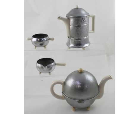 An Art Deco ceramic and pewter four-piece tea service to include a teapot, hot water pot, milk jug and sugar bowl (4).