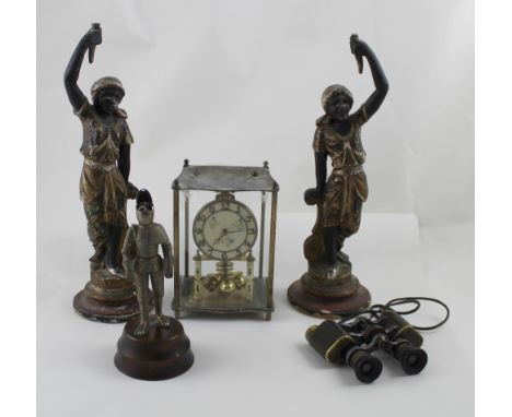A pair of 19th century painted gesso and parcel gilt Blackamoor figures, each holding aloft remnants of a torchère, on turned