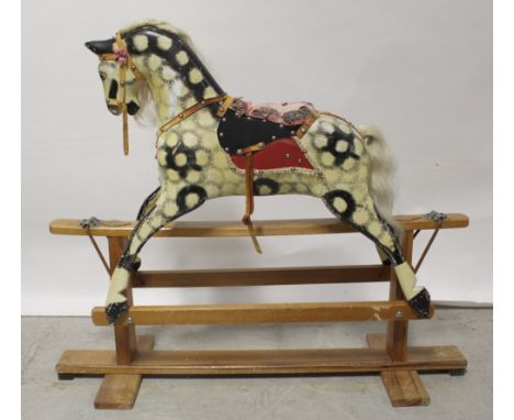 A vintage dapple grey children's rocking horse, length 103cm, height 90cm.