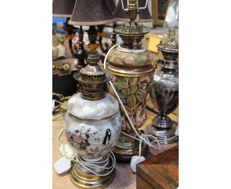 Two early 20th century oil lamps, one mottled ceramic example to steppes circular brass base and a ceramic and brass example 