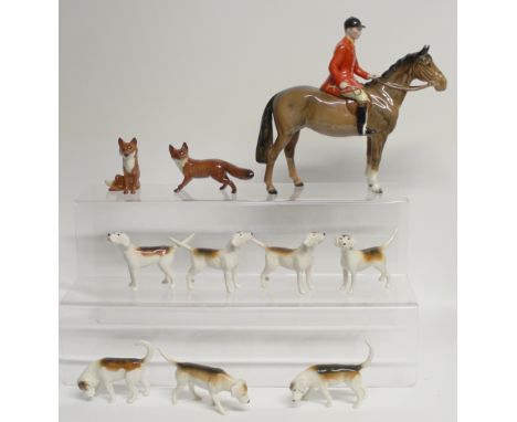 A Beswick brown gloss standing 'Huntsman' no.1501, two foxes no.1440 standing and no.1748 seated, and seven hounds, first ver