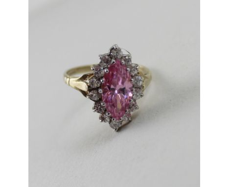 A 9ct yellow gold ladies' dress ring, central marquise-set pink stone with white stone surround, size L, approx 3.2g.