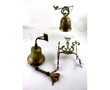 Two vintage brass pub 'Time' bells, one with ornate figural winged wall bracket and inscription to bell, height of largest 19