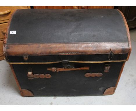 A 19th century black domed-top seaman's trunk with brown leather trim and leather carrying handles, length 77cm.