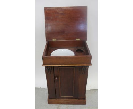 A 19th century mahogany wash stand, lift-up lid reveals enamel bowl to interior over single cabinet door on square base, heig