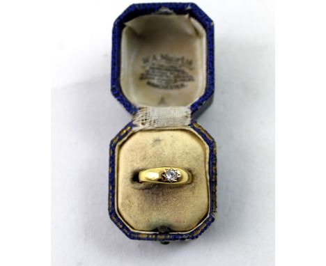 An Edwardian gold dress ring, starburst set with a solitaire diamond, size N, approx 2.3g.