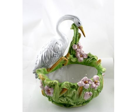 A 20th century Majolica-style ceramic jardinière in the form of a heron sitting on a foliate base, width 38cm.