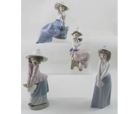 Four Nao figures of girls wearing hats, one holding a puppy (4).