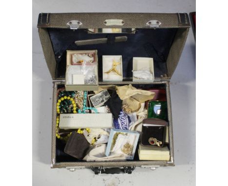 A vintage vanity case containing a quantity of vintage jewellery, necklaces, brooches, rings etc.