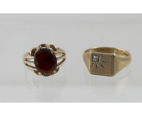 Two 9ct yellow gold gentlemen's dress rings, a signet ring with small white stone, size V and a dress ring with oval garnet, 