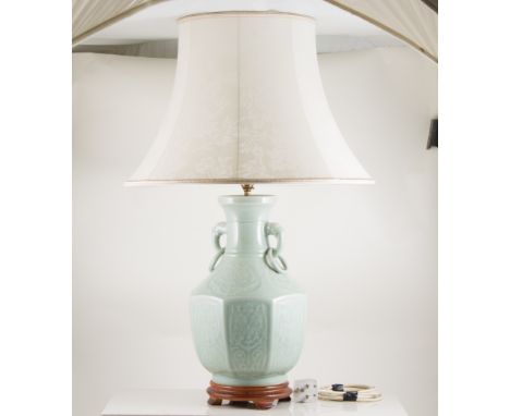 Pair of table lamps, celadon ceramic on wooden bases, elephant handles, 43cm high with shades.