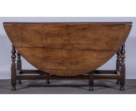 A joined oak gate-leg table, basically 18th century, oval top, turned legs, plain rails, 145cm x 170cm.