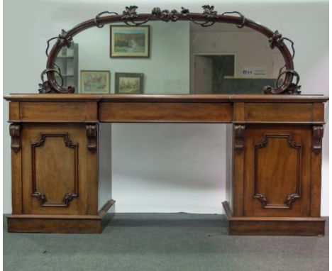 Victorian mahogany sideboard, arched mirrored back, with carved surround, inverted break-front top with a moulded edge, three