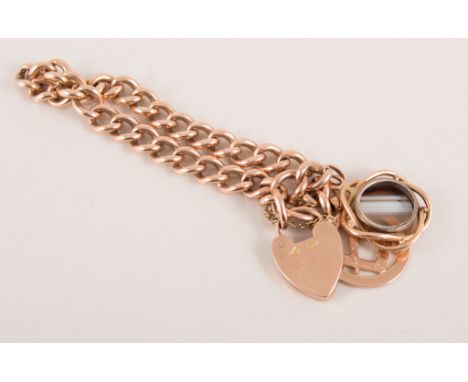 9 carat rose gold solid curb link charm bracelet, fitted with a padlock fastener and safety chain, two charms attached, a mas