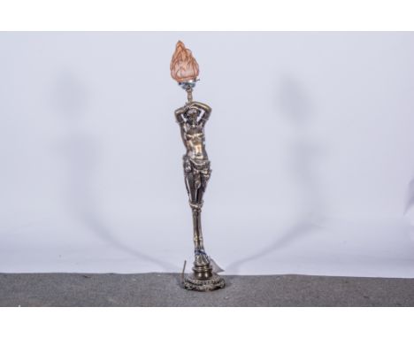 An unusual figural table lamp, early 20th century, patinated part metal, cast as a female satyr, supporting a peach glass fla