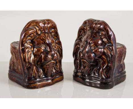 Set of four treacle-glazed sash window stoppers - lion masks.