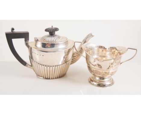 Small silver teapot in the Regency style with fluted base, by J.M.B., a silver pepperette, a silver loving cup, again by J.M.