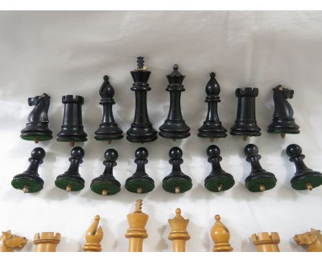 A set of light wood and ebonised wood chess pieces, the bases fixed with a dowel for play on a drilled board, height of king 
