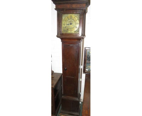 A thirty hour striking long case clock in an oak case with a blind fret frieze to the hood. The square brass face with brass 