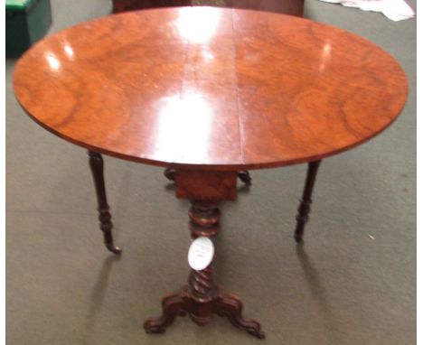 A Victorian oval gate leg tea table, the top with quarter walnut veneer on spiral turned supports, baluster turned stretcher 