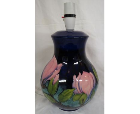 Moorcroft pottery magnolia table lamp, baluster shape, dark blue ground, pink flowers, the base stamped MOORCROFT MADE IN ENG