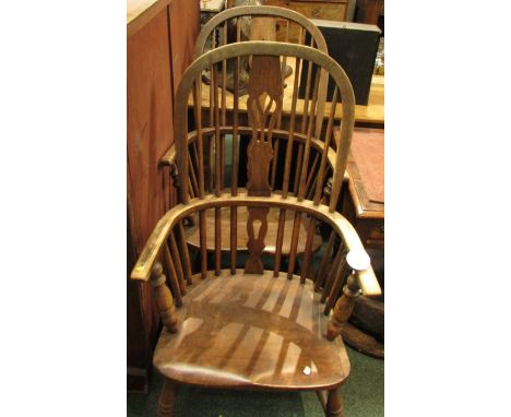 A near pair of elm stick back Windsor chairs with pierced baluster splats, heights 110cm