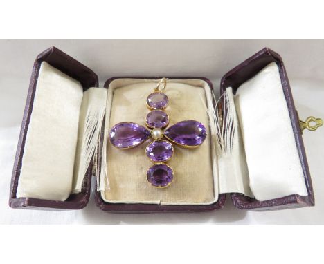 An amethyst cross pendant of six gems with a seed pearl to the middle, the centre line of four oval cut amethysts of subtly v