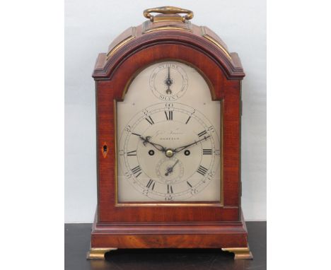 Mahogany striking bracket clock with domed top, hinged brass carry handle, the top with three brass edged panels, sound grill