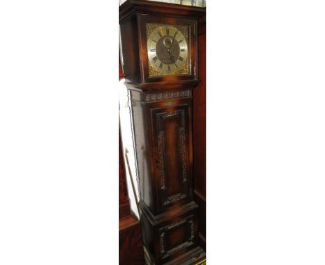 An early 20th century chiming oak long case clock with a square hood, carved roundel frieze and blind fretwork to the door an