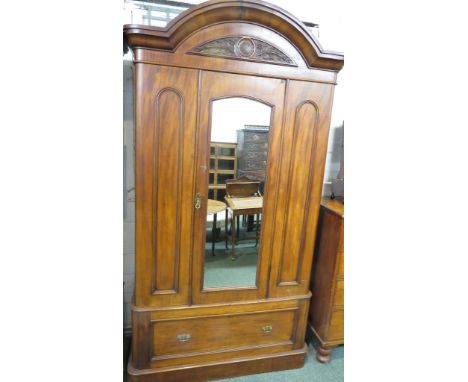 Victorian mahogany arch topped wardrobe, the single mirrored door between two moulded panels, the interior with rail and clot