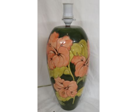 Moorcroft pottery hibiscus table lamp, tall ovoid shape, green ground, pink flowers, the base stamped MOORCROFT ENGLAND, heig