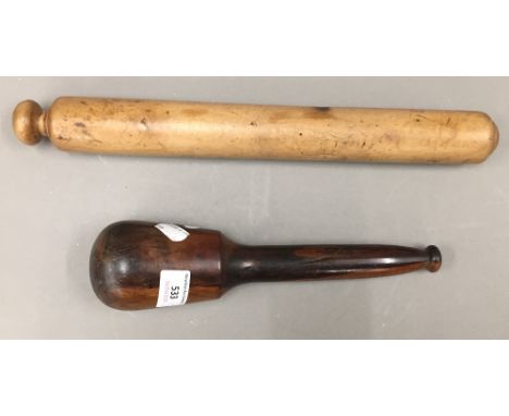 A vintage treen rolling pin and a lignum vitae pestle