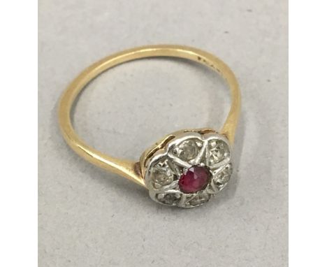 A diamond and ruby flower head ring (1.9 grammes total weight)